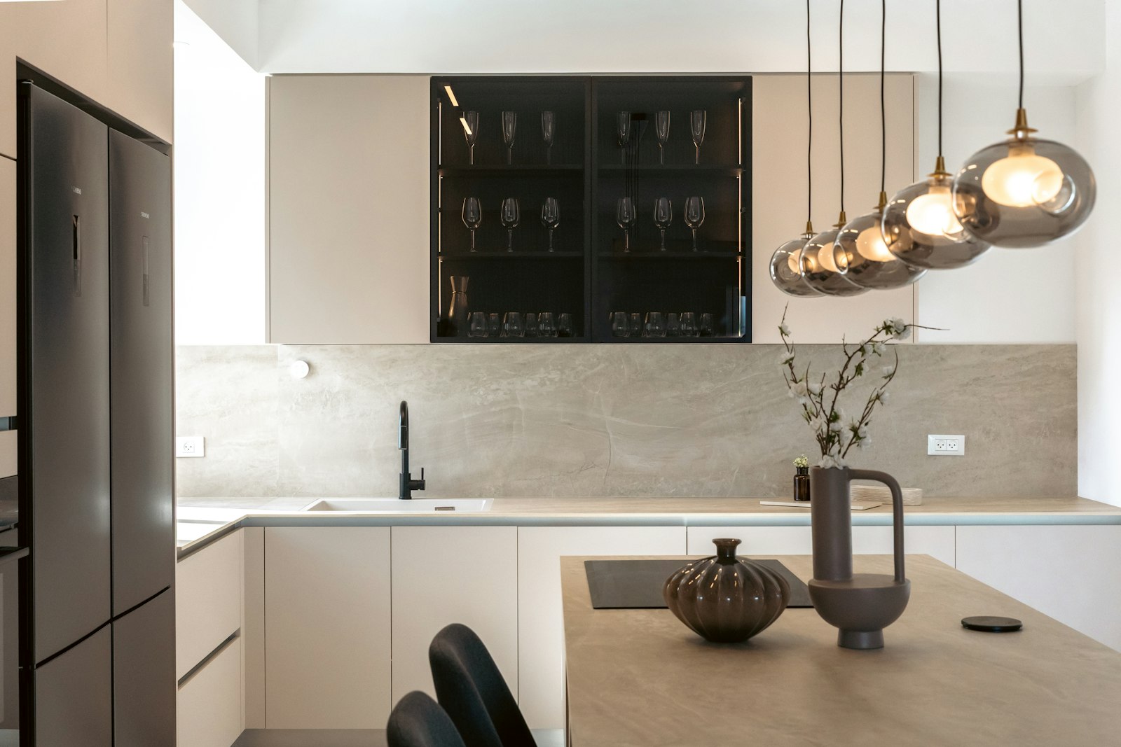 The Kitchen, with marble counters and a glass-fronted cabinet of stemware.